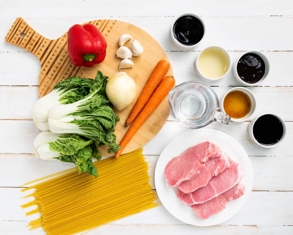 instant pot lo mein ingredients on white wood table