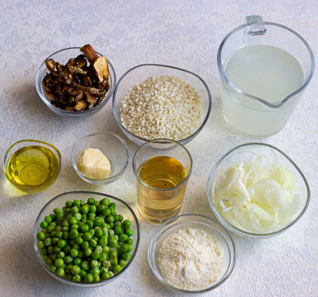 risotto with peas ingredients in bowls on countertop