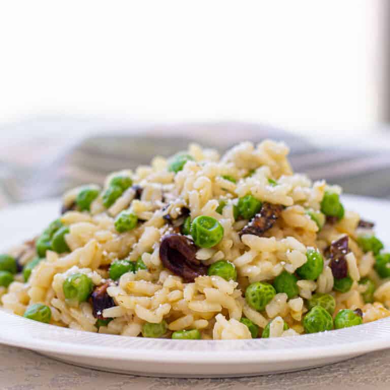 risotto with peas on white plate