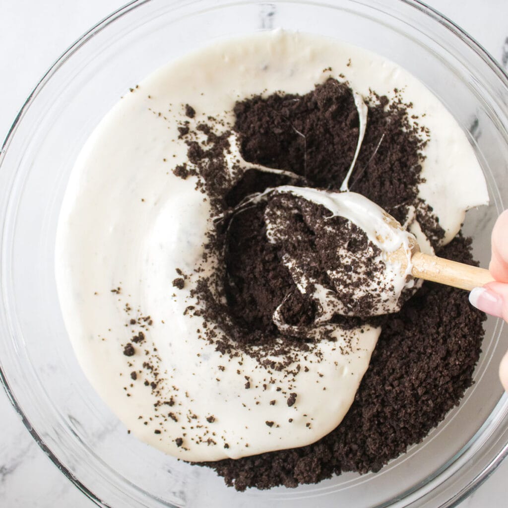 stirring melted marshmallow and crushed oreos