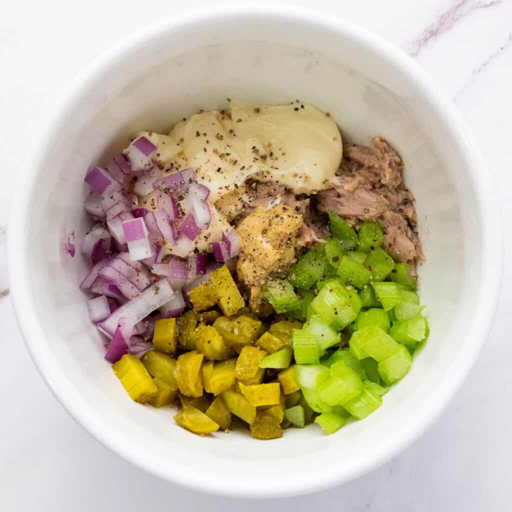 tuna salad ingredients together in bowl