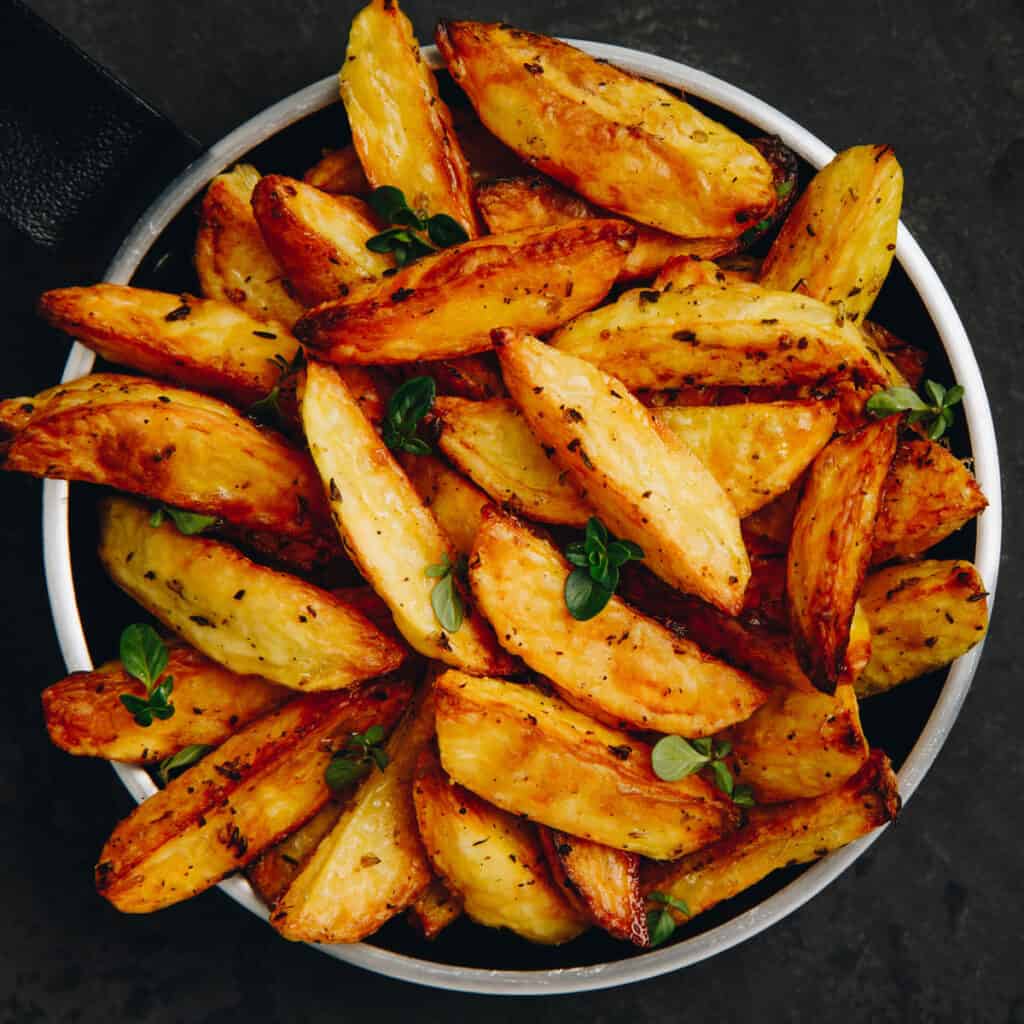 fried potatoes in metal bowl