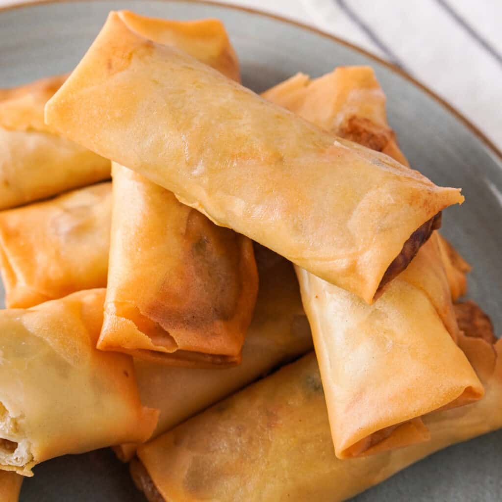 egg rolls on blue plate