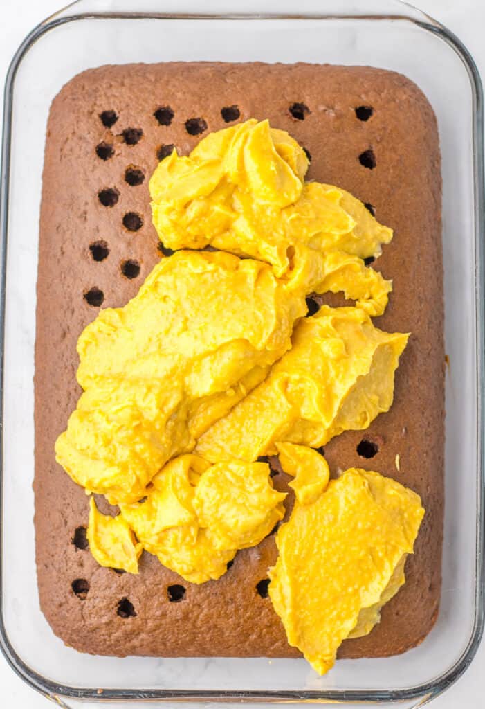 spreading peanut butter on peanut butter poke cake