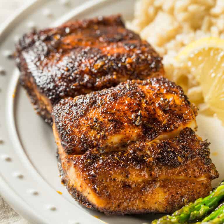 blackened fish on cream plate