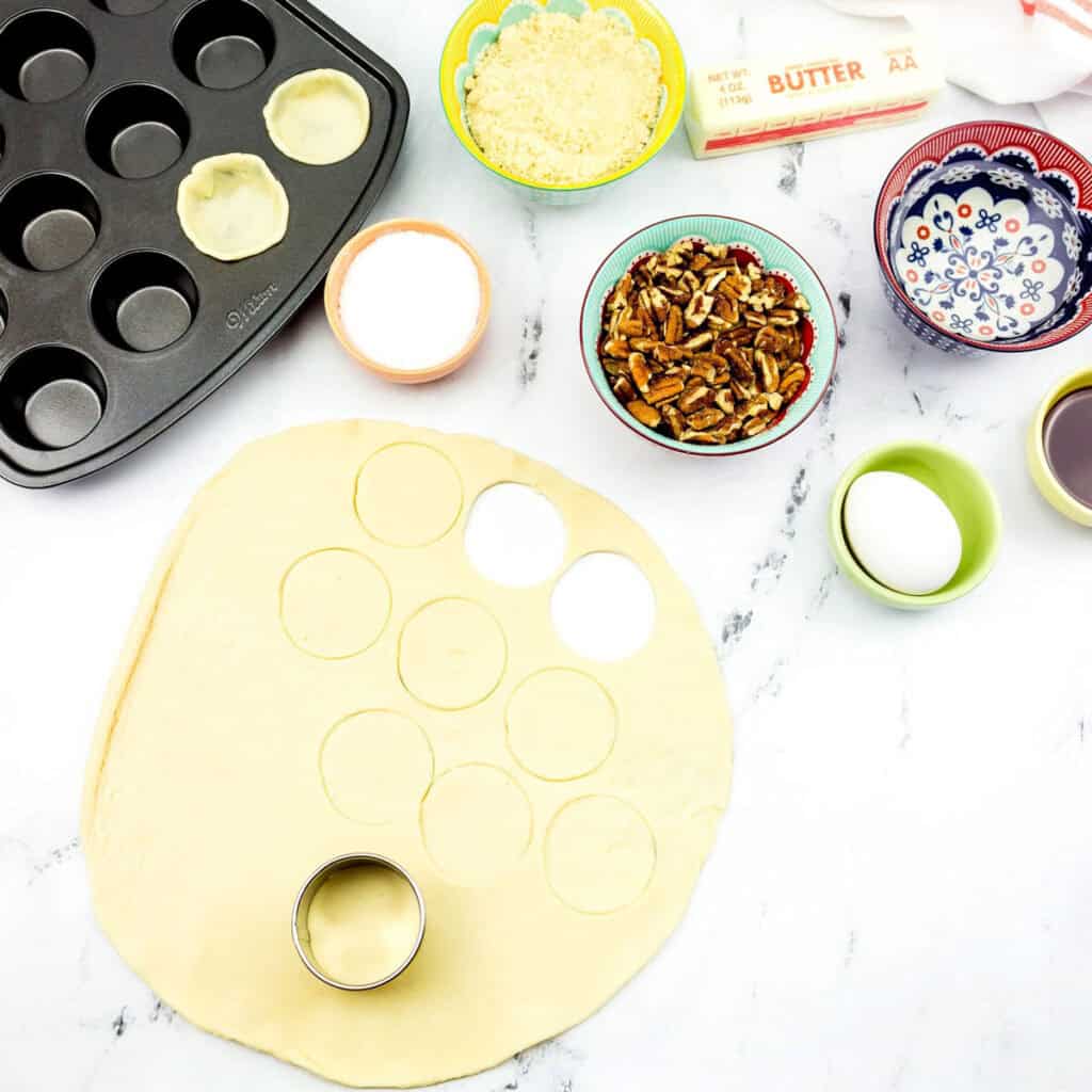cutting pie crust to make mini pecan tarts