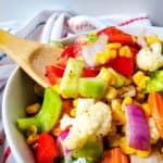 colorful vegetable salad with wooden spoon