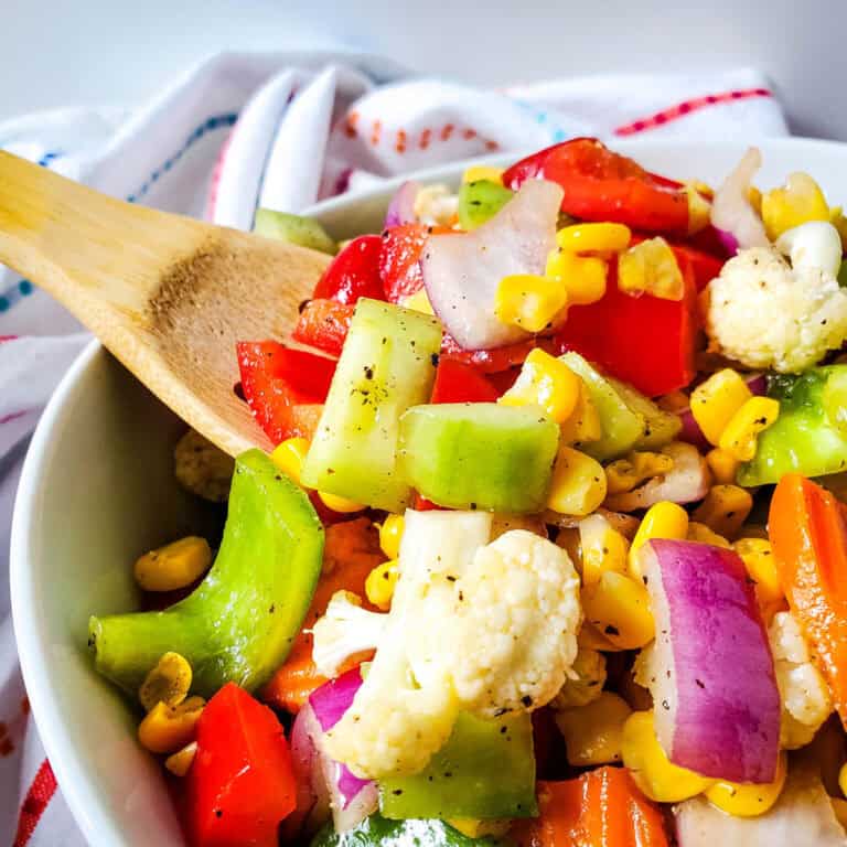 colorful vegetable salad with wooden spoon