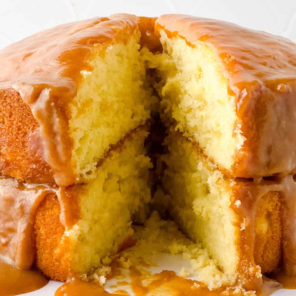 two layer caramel cake with one piece removed