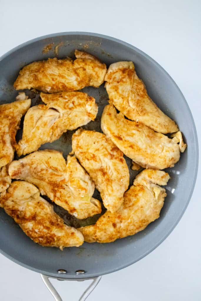 chicken breasts cooking in pan