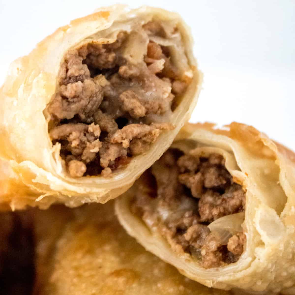 close up of cheeseburger eggroll cut in half