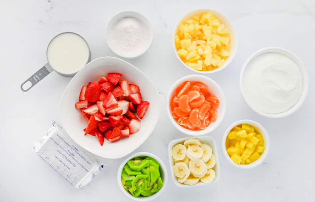 Hawaiian cheesecake salad ingredients in bowls on counter