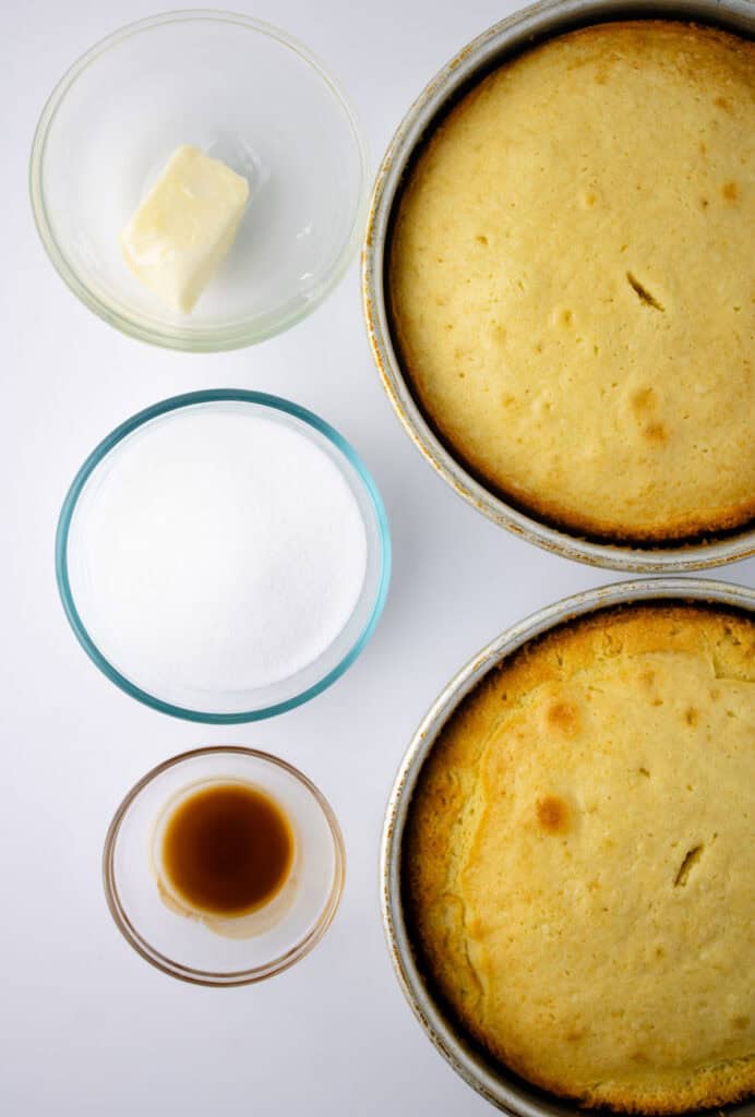 two caramel cakes in pans with glaze ingredients in bowls