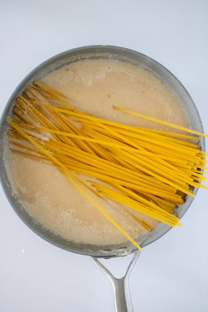 fettuccine in pot of sauce