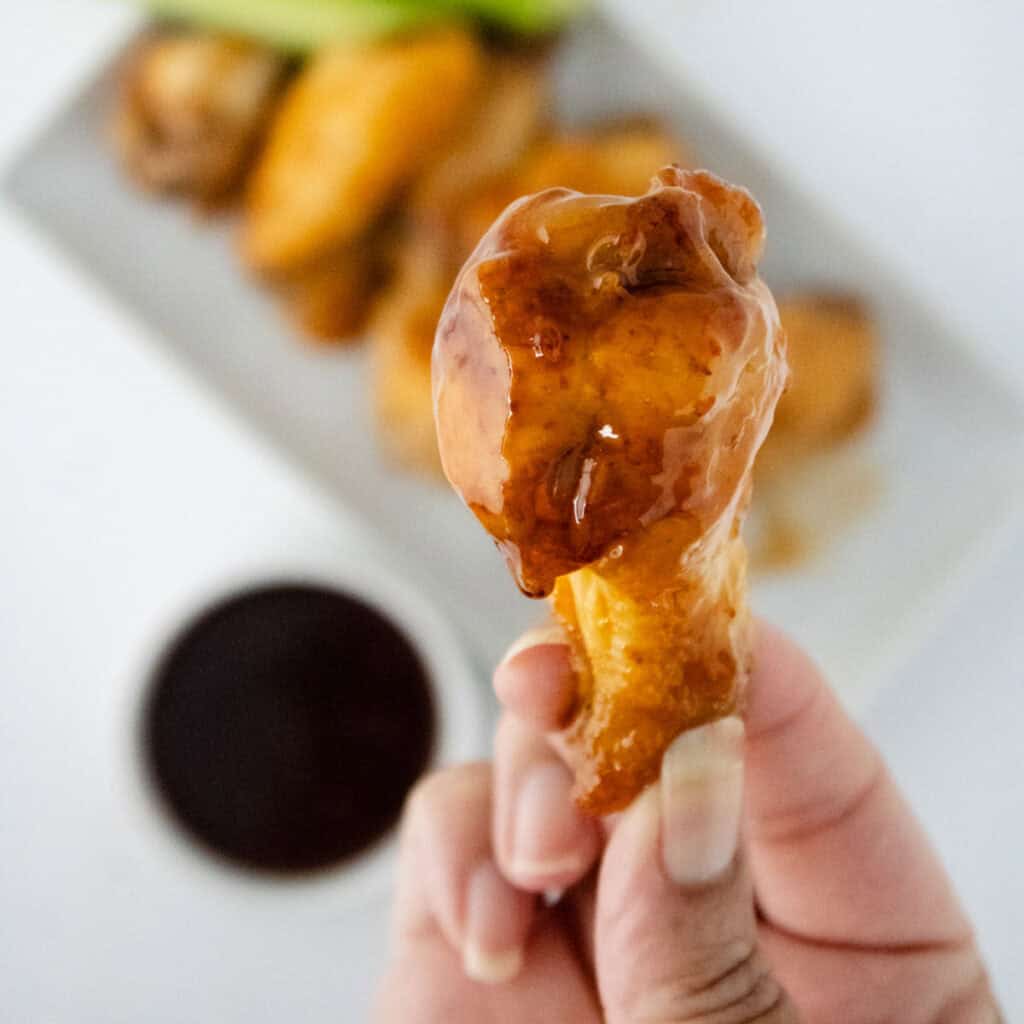 sweet chili wings drumstick in hand