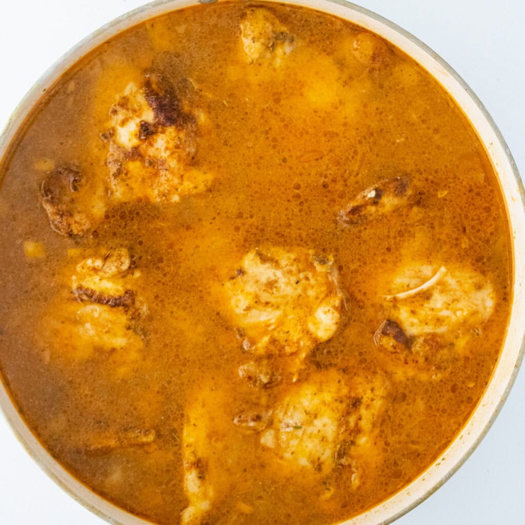 One Pot Chicken and Rice cooking in skillet