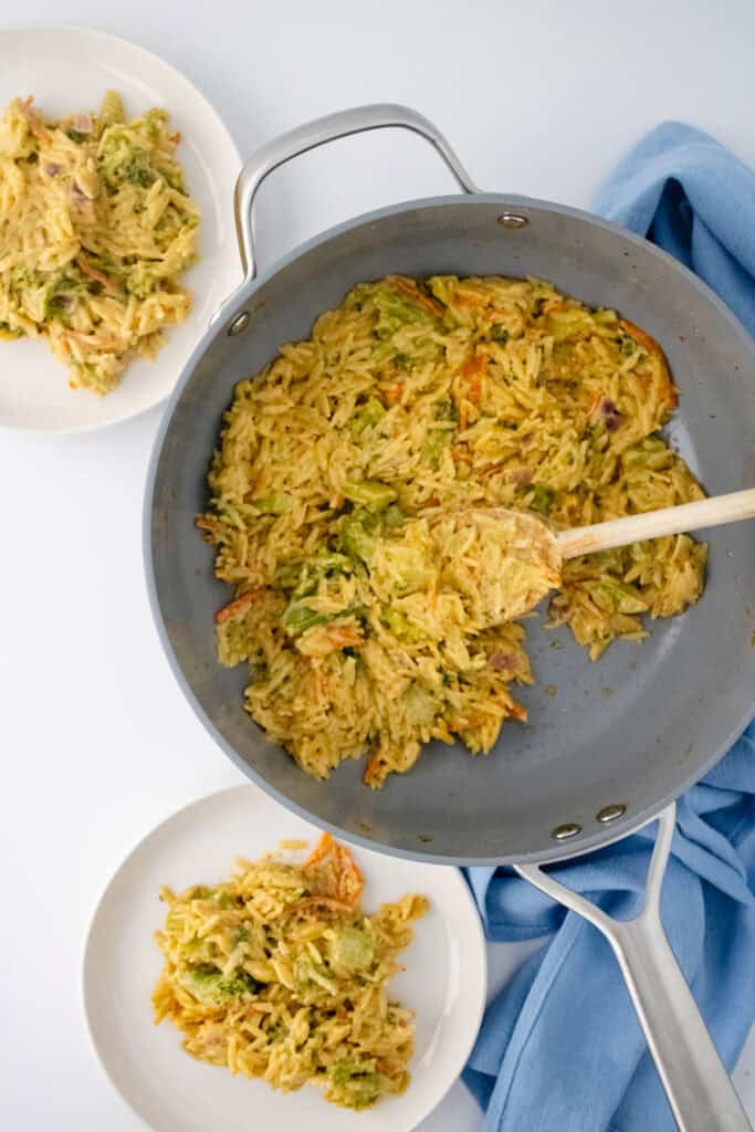 broccoli cheddar orzo in pot and on two plates