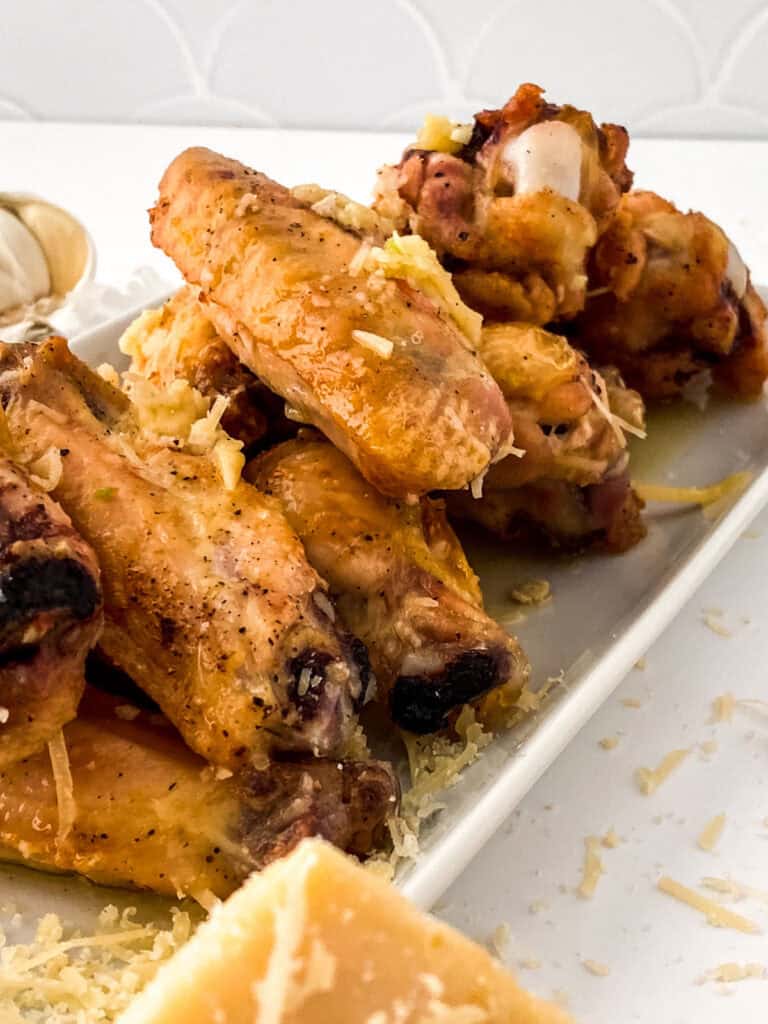 garlic parmesan wings on white plate
