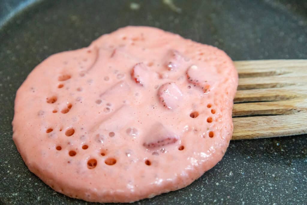 flipping strawberry pancakes