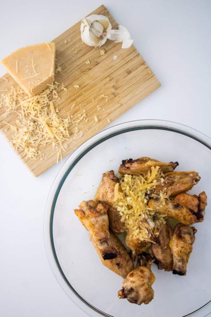 wings in mixing bowl with parmesan cheese