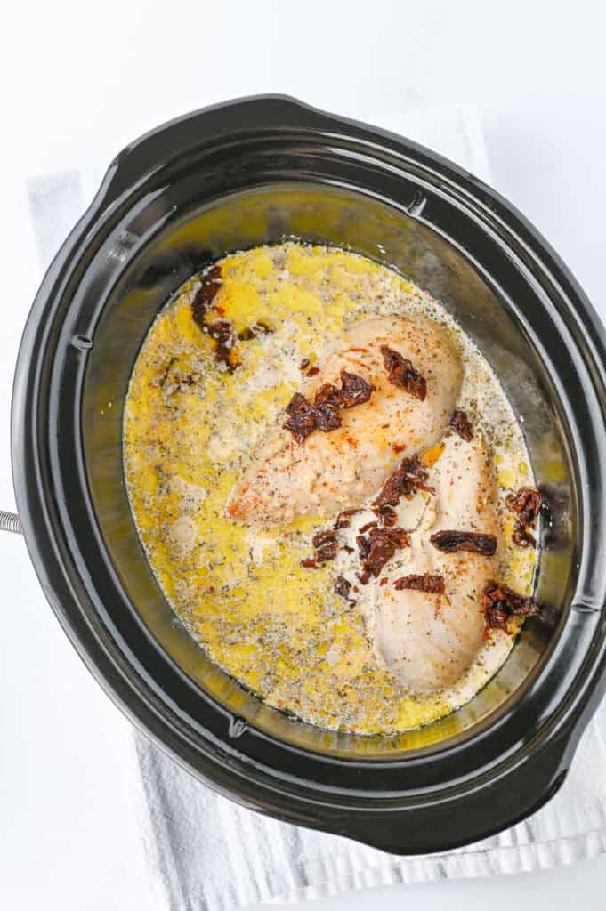 Slow cooker marry me chicken cooking in crock pot
