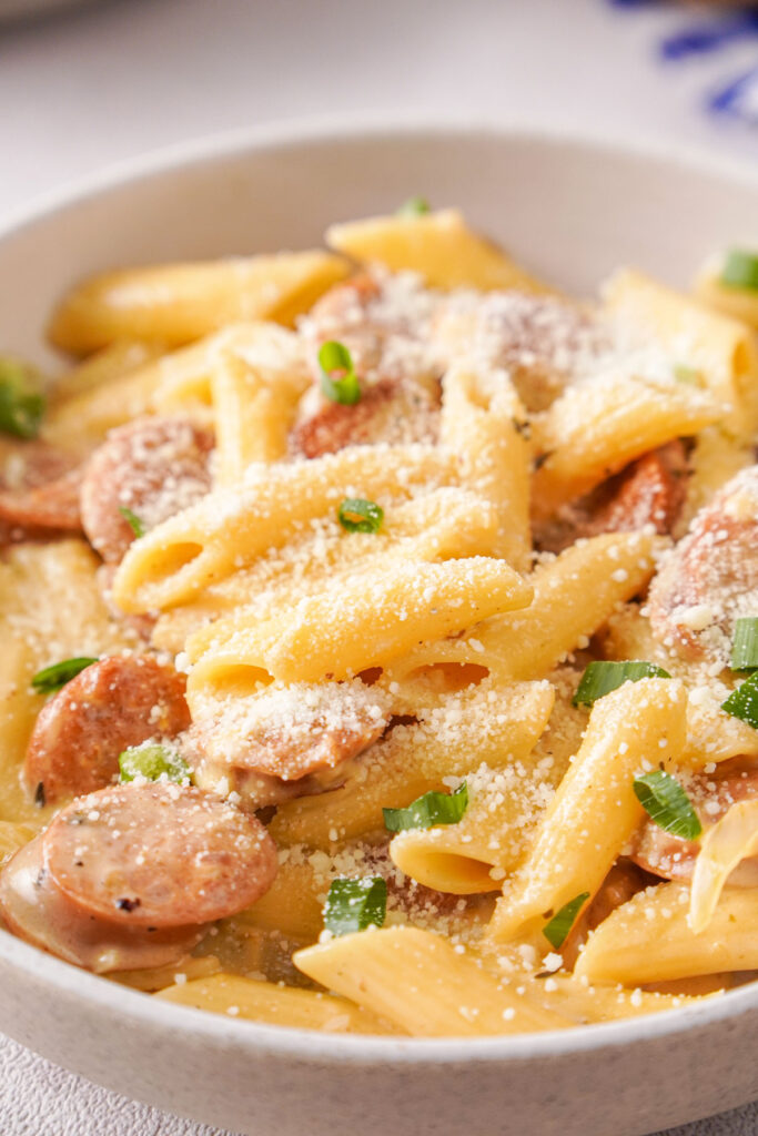 white bowl with cheesy kielbasa pasta