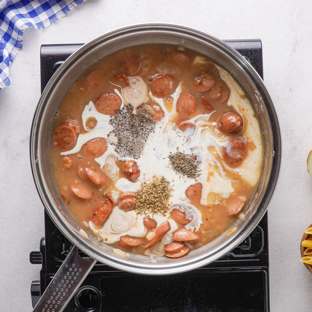 making cheesy kielbasa pasta