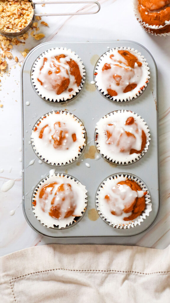 glazed pumpkin muffins in muffin tin