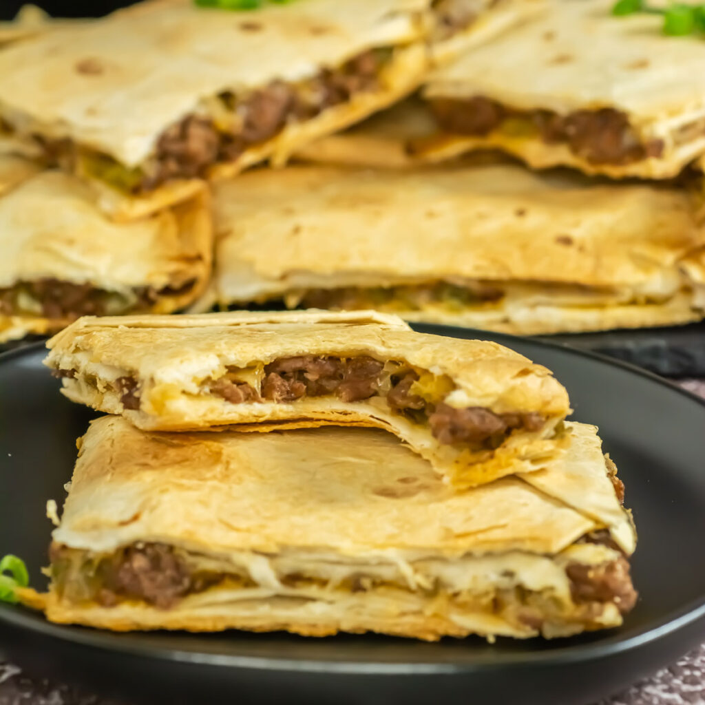 sheet pan quesadillas with one bitten out of