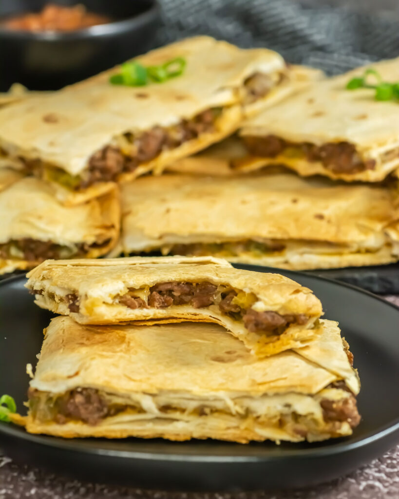 sheet pan quesadillas on plate with one bitten