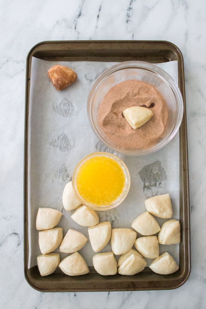 cut up biscuit dough with melted butter and cinnamon sugar