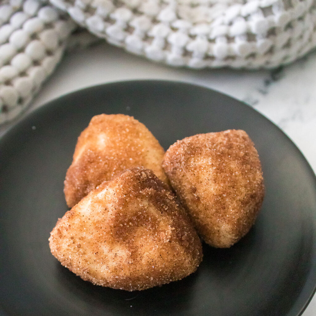 3 Cinnamon Sugar Biscuit Bites on black plate