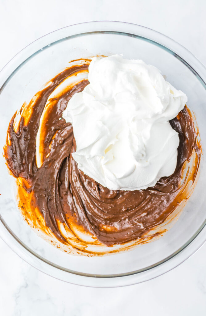 mixing pudding and cool whip in bowl