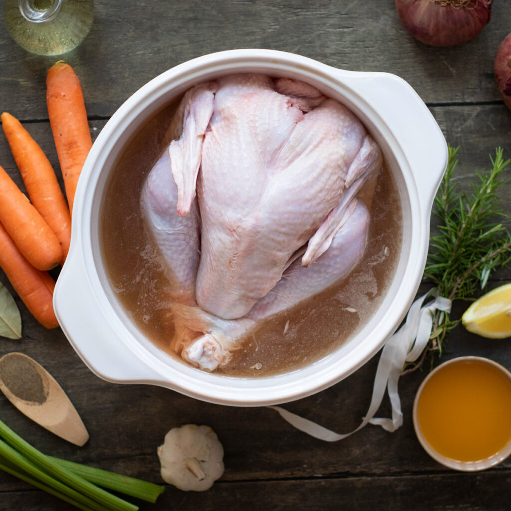 raw turkey soaking in pot of brine