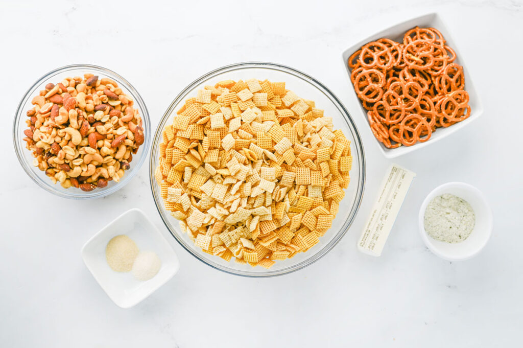 slow cooker chex mix ingredients in bowls on counter