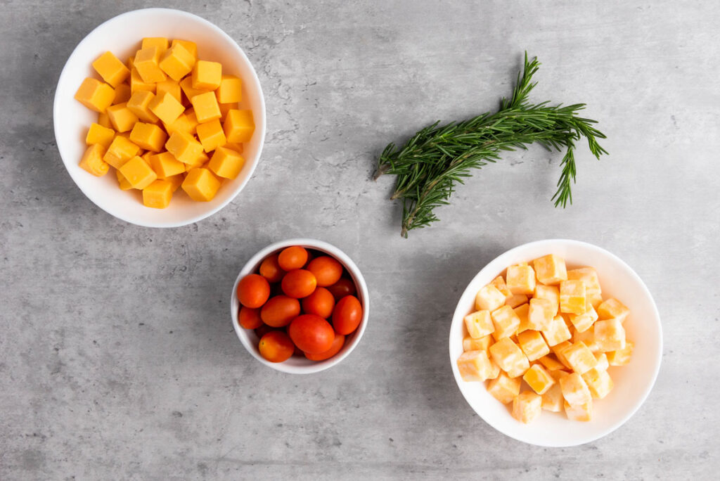 Christmas tree cheese platter ingredients in bowls on counter