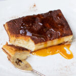 piece of churro cheesecake bars with bite on fork