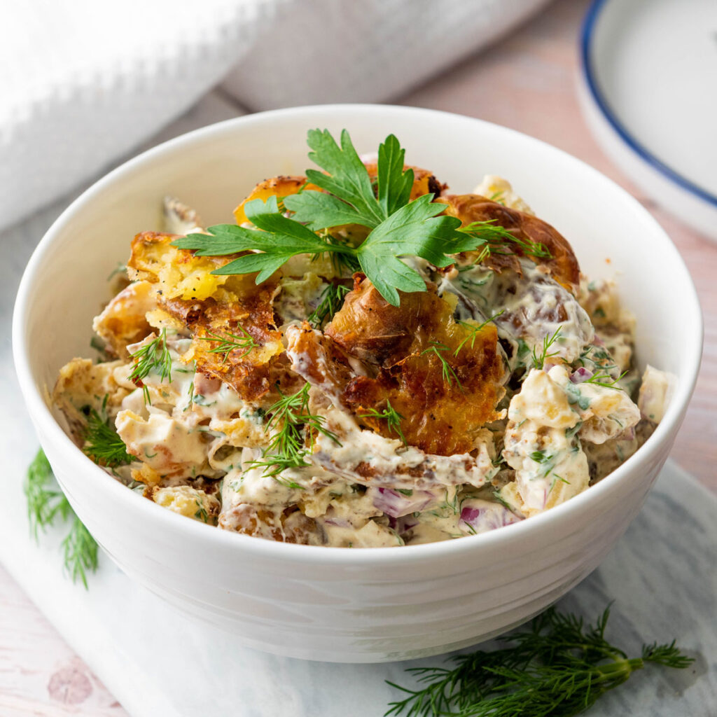 white bowl with smashed potato salad