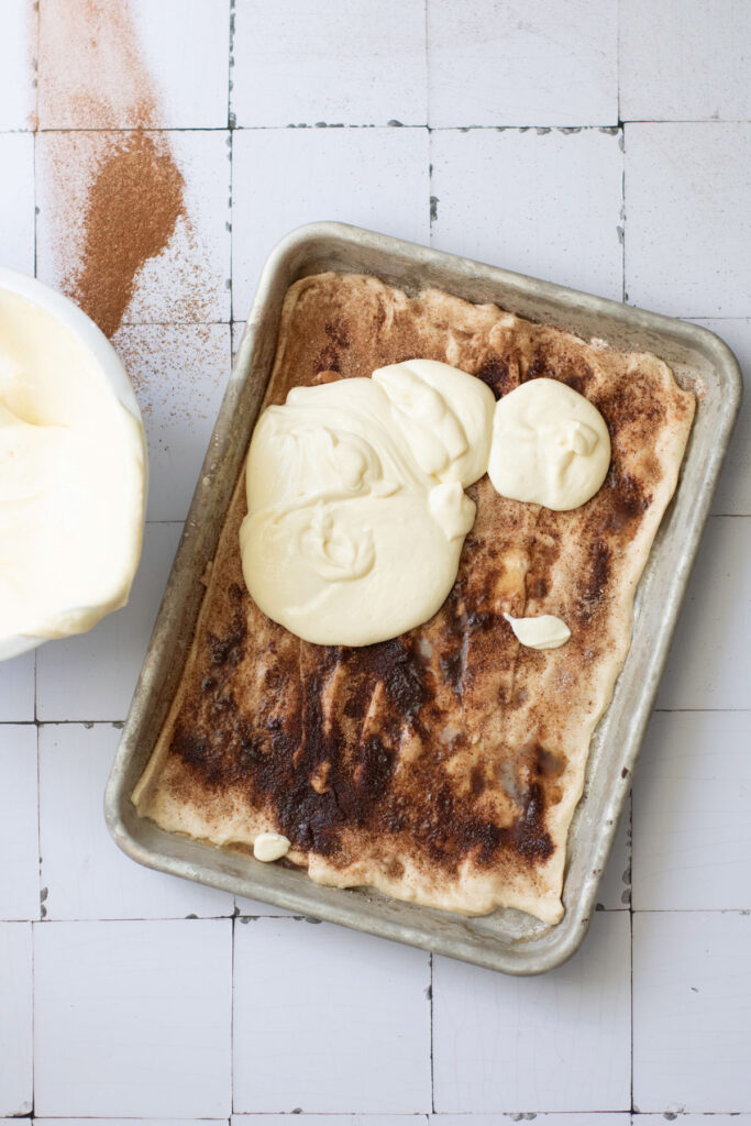 pouring cheesecake filling over churro dough