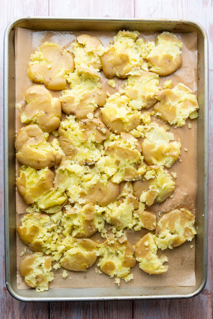 smashed potatoes on baking sheet