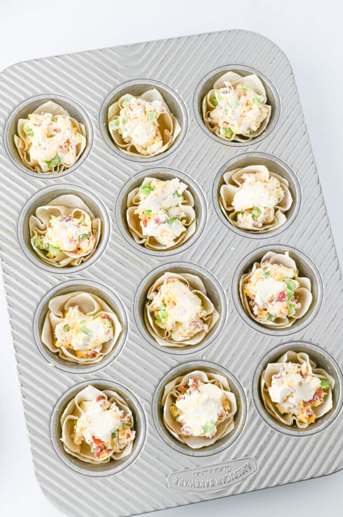 wontons with jalapeño popper filling in muffin tin