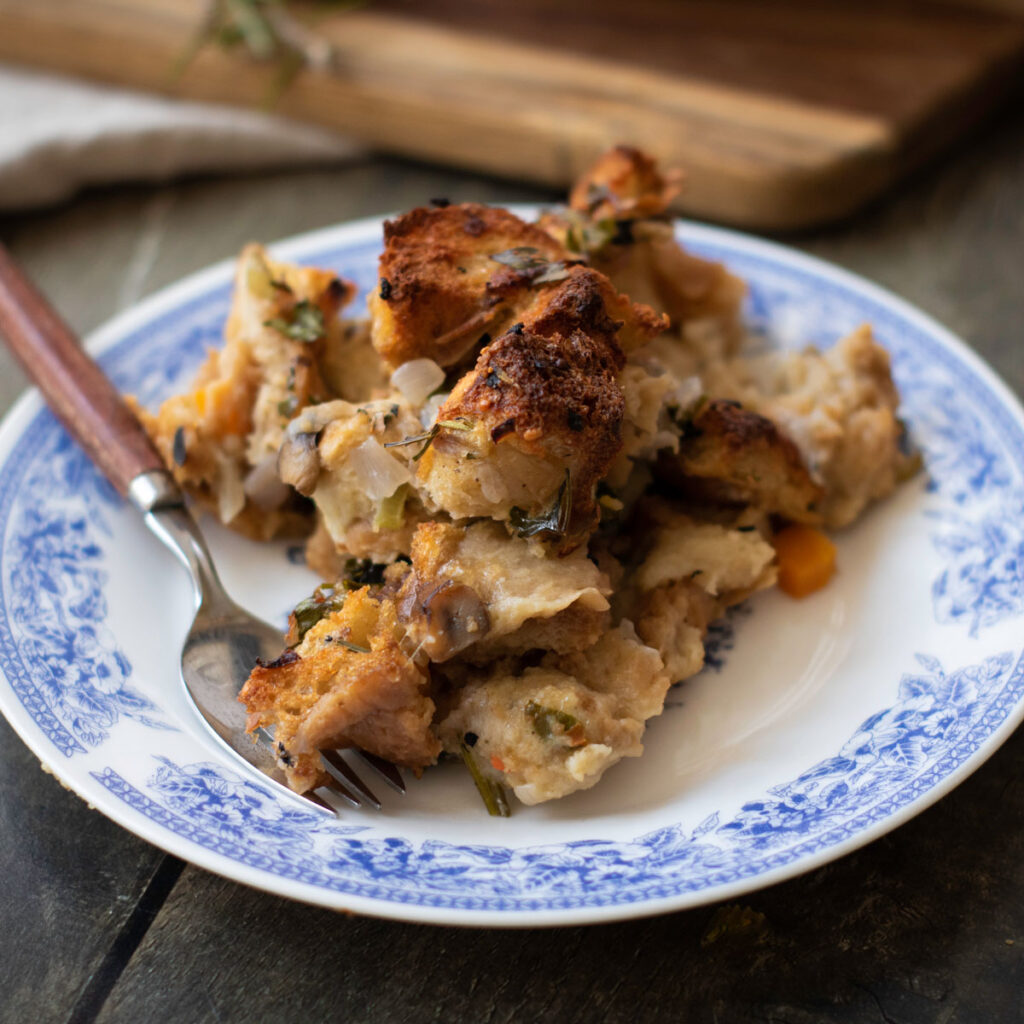blue and white plate with serving of vegetable herb stuffing