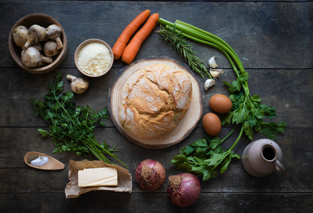 vegetable herb stuffing ingredients on dark countertop