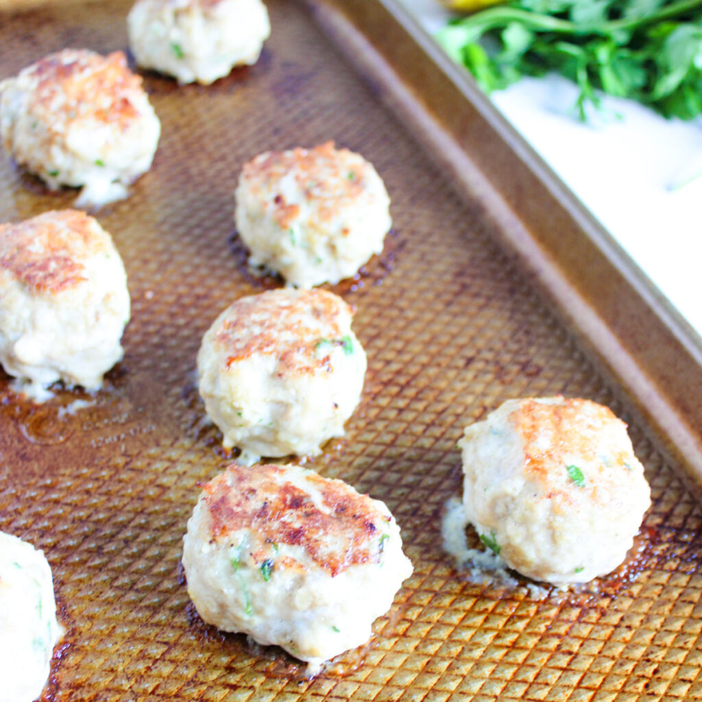 chicken meatballs on baking sheet