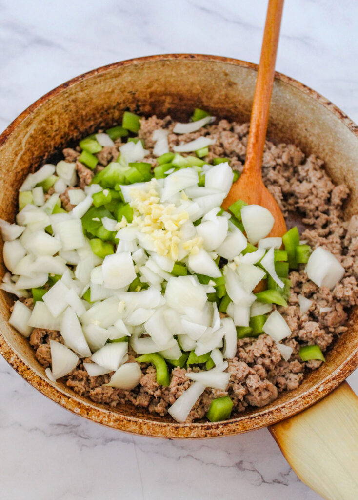 browning ground beef, onion, and chopped bell pepper in skillet