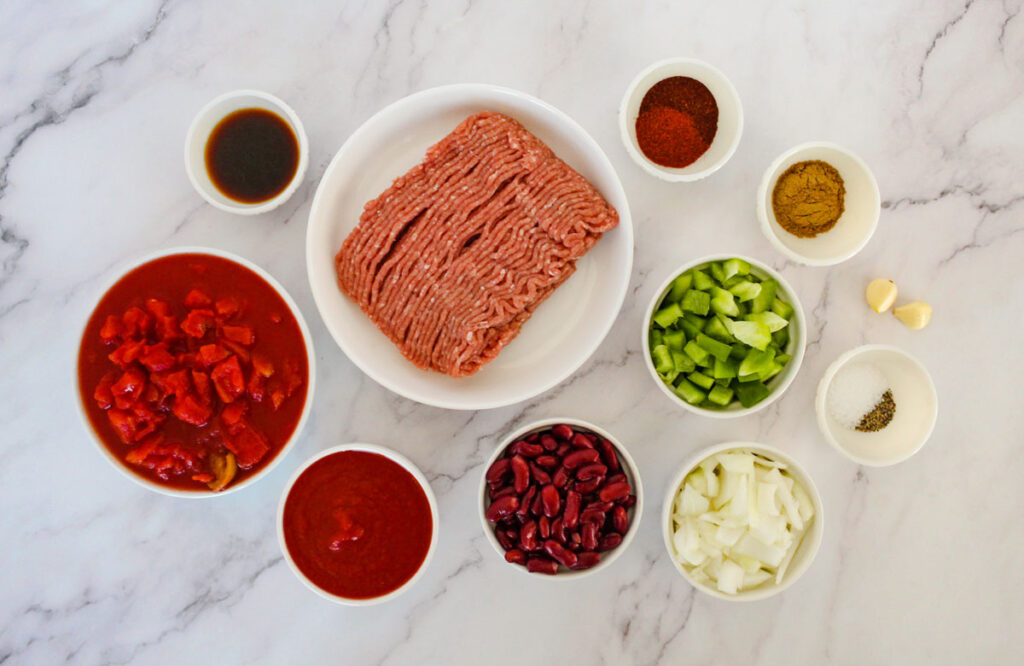 crock pot chili ingredients in bowls on counter
