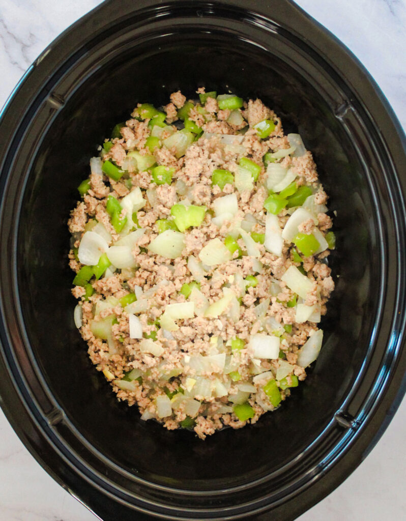 browned ground beef and vegetables in slow cooker