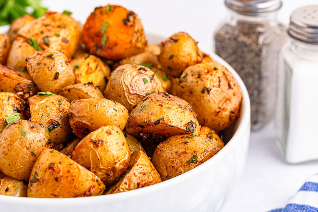 crispy roasted potatoes in white bowl