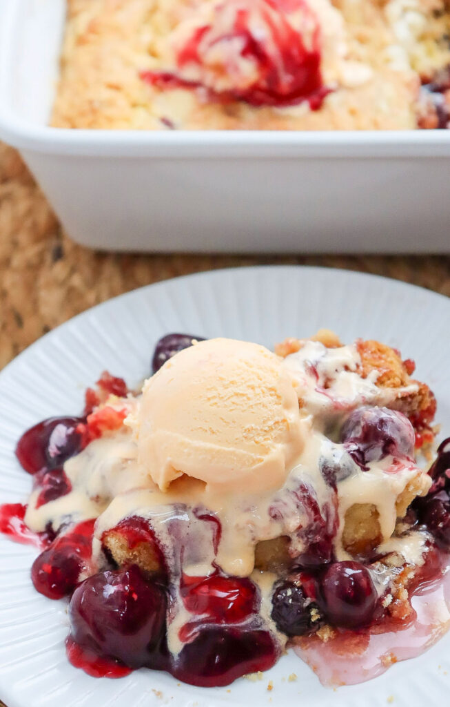 cherry dump cake with scoop of vanilla ice cream