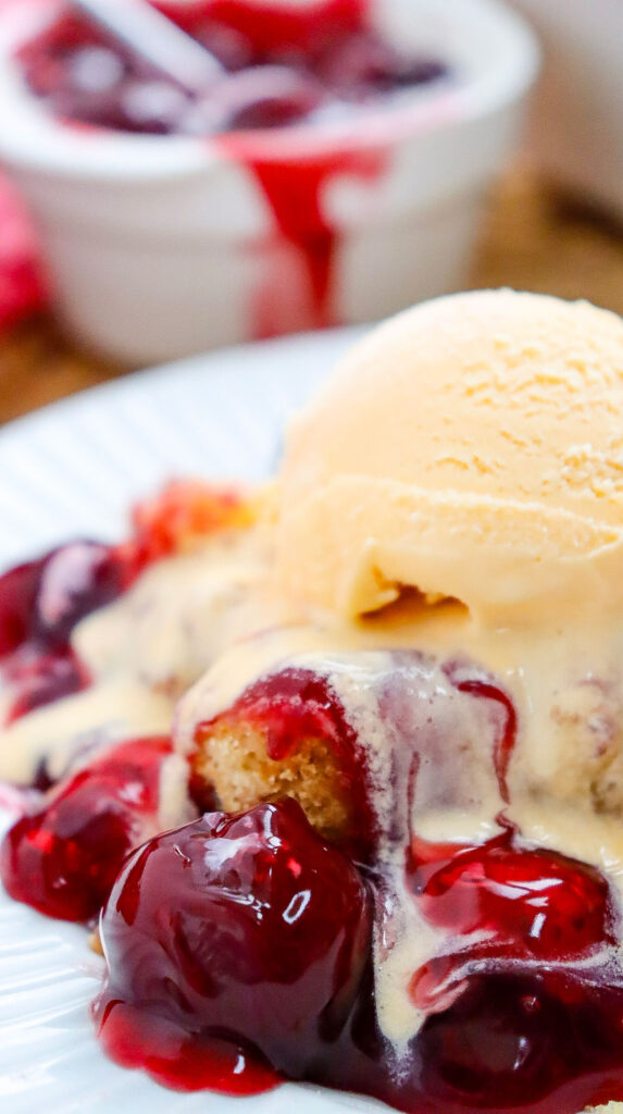 cherry dump cake with scoop of vanilla ice cream